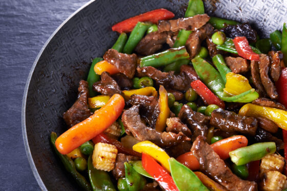 Beef and vegetable stir-fry in wok Beef and vegetable stir-fry in wok